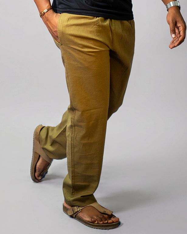 LORËVEN Linen Cotton Trouser in Tobacco Brown — waist-down detail shot of the trouser leg paired with brown leather sandals, against a neutral grey studio background